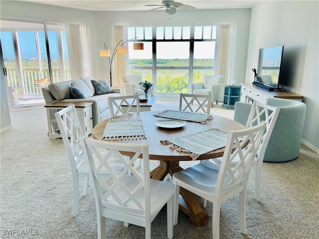 dining room with carpet, ceiling fan, and baseboards