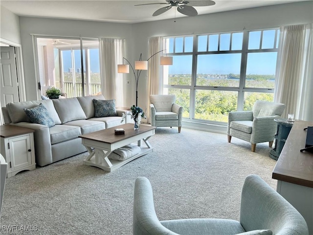 carpeted living area featuring ceiling fan