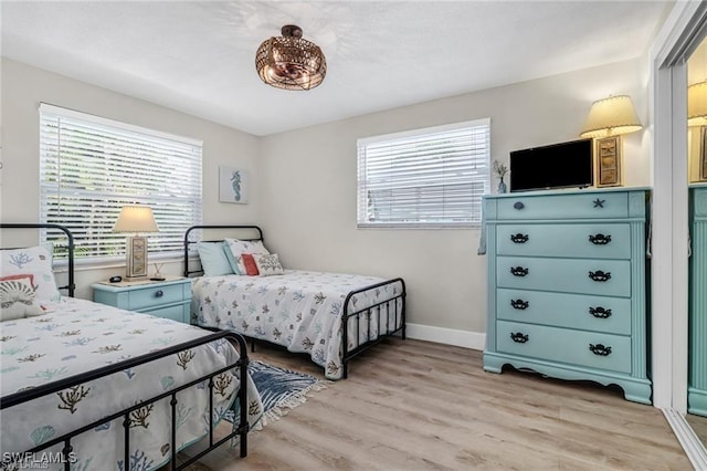 bedroom featuring light wood-type flooring and baseboards