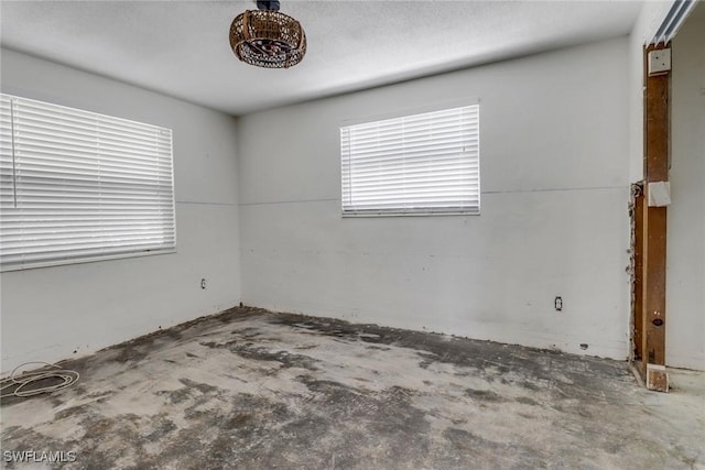 spare room featuring concrete flooring