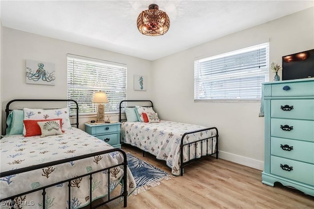 bedroom featuring baseboards and light wood-style floors