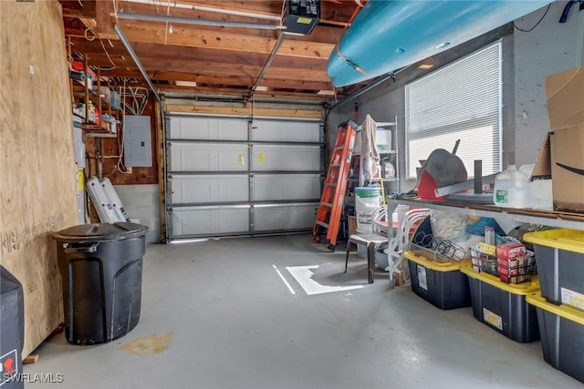 garage featuring electric panel and a garage door opener