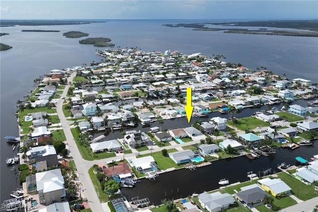 birds eye view of property with a residential view and a water view