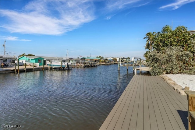 dock area with a water view and boat lift