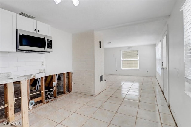 interior space featuring visible vents and light tile patterned floors