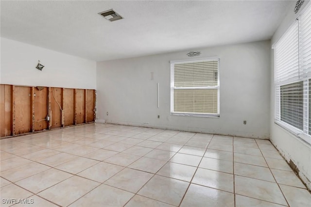 unfurnished room featuring light tile patterned floors and visible vents