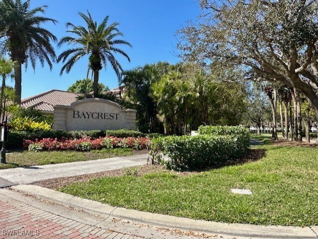 community sign featuring a yard