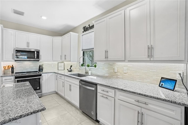 kitchen featuring a sink, visible vents, appliances with stainless steel finishes, and white cabinetry