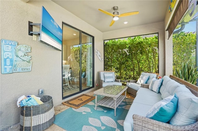 sunroom / solarium with a ceiling fan