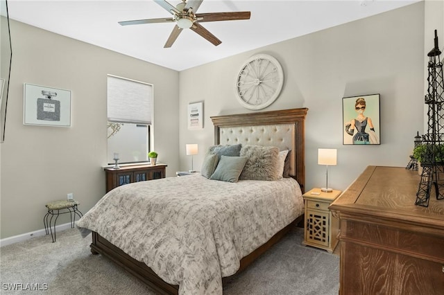 carpeted bedroom featuring baseboards and a ceiling fan