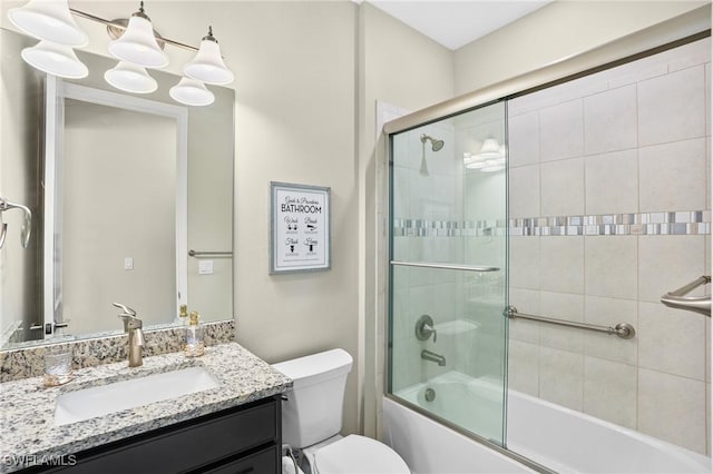 bathroom with vanity, a notable chandelier, toilet, and combined bath / shower with glass door