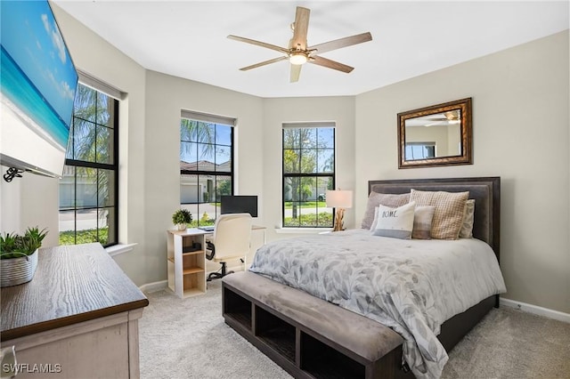 carpeted bedroom with baseboards and a ceiling fan