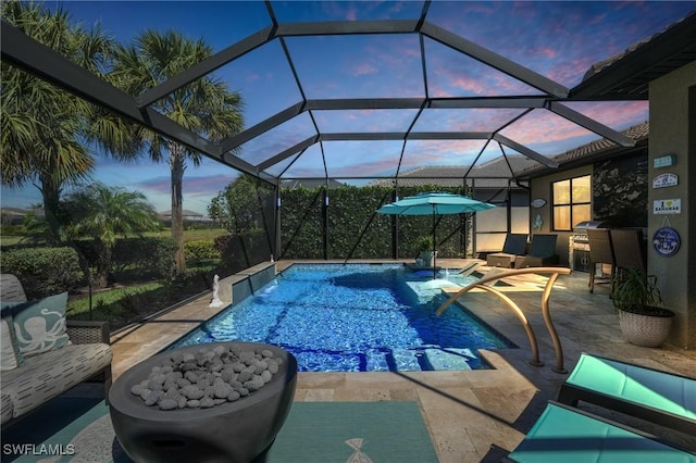 pool at dusk featuring a patio and an outdoor pool