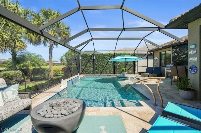 outdoor pool featuring glass enclosure and a patio