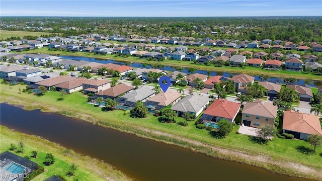 birds eye view of property with a residential view and a water view