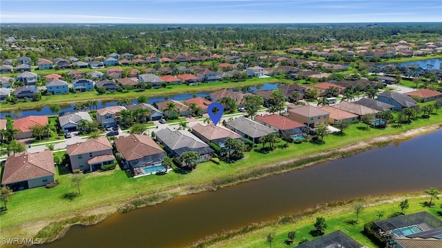 birds eye view of property featuring a residential view and a water view