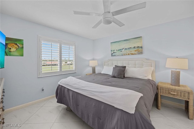 bedroom featuring marble finish floor, a ceiling fan, and baseboards