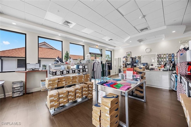 interior space with a paneled ceiling, visible vents, wood finished floors, and recessed lighting