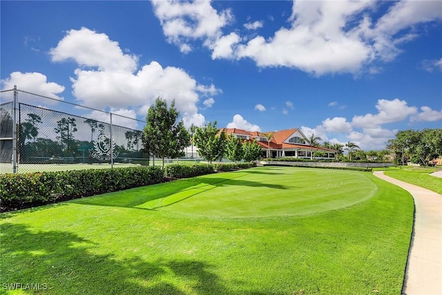 surrounding community with a yard and fence