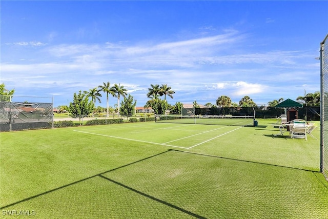 view of tennis court featuring fence