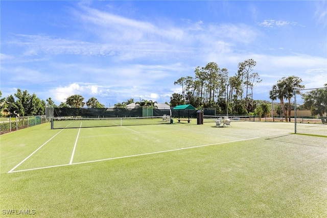 view of tennis court featuring fence