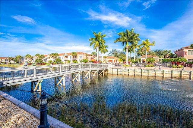 dock area with a residential view and a water view