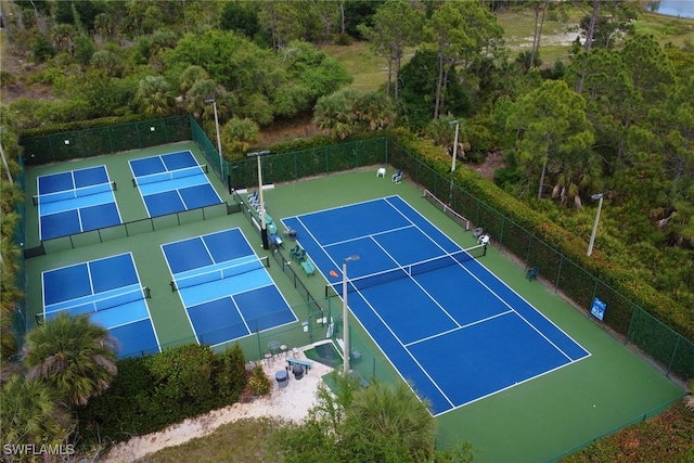 view of tennis court featuring fence