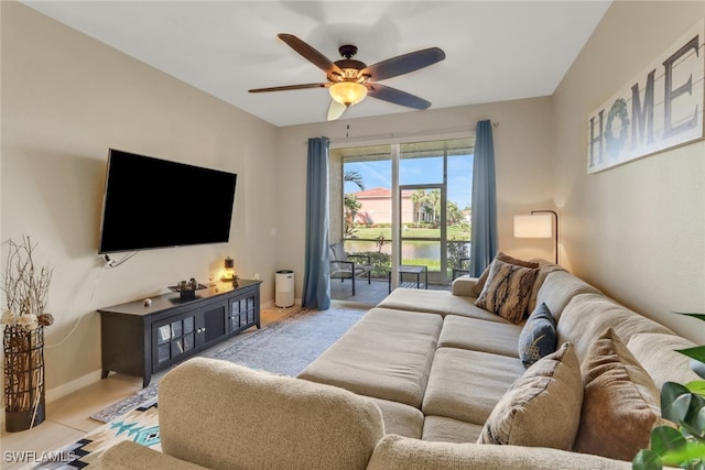 living room with a ceiling fan and baseboards