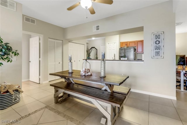 dining area featuring light tile patterned flooring, visible vents, and baseboards