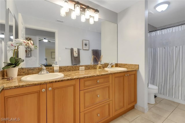 bathroom featuring double vanity, a sink, visible vents, and tile patterned floors
