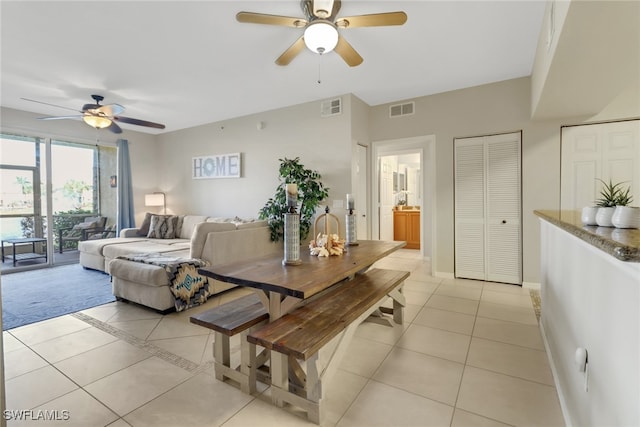 dining area with light tile patterned floors, a ceiling fan, visible vents, and baseboards