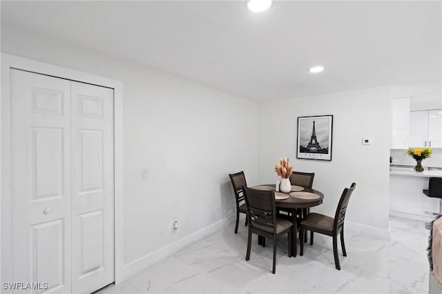 dining area with marble finish floor, baseboards, and recessed lighting