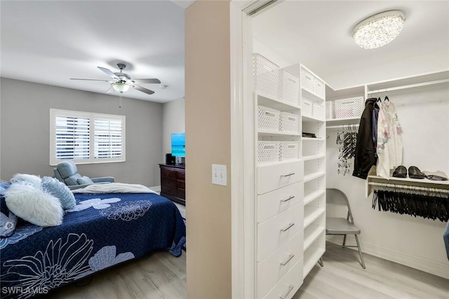 bedroom with wood finished floors, a ceiling fan, and baseboards