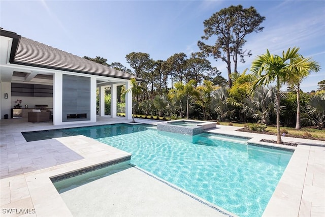 view of swimming pool with a pool with connected hot tub and a patio