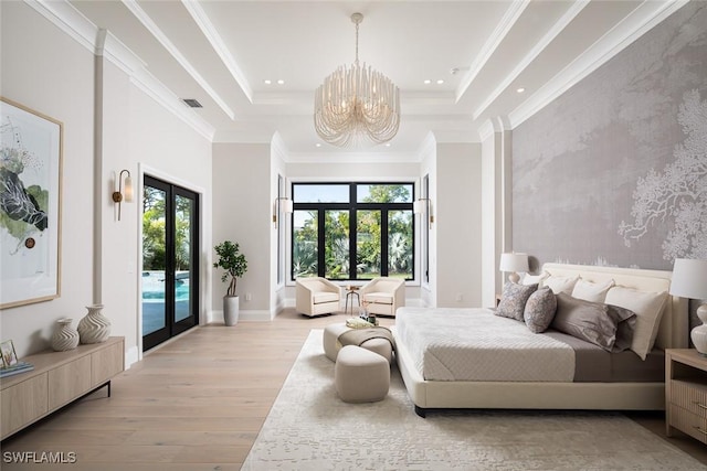 bedroom with access to exterior, light wood-style flooring, a raised ceiling, and french doors