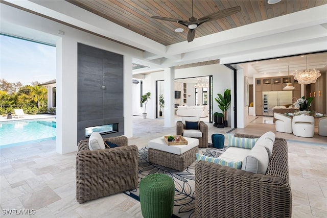 view of patio featuring a ceiling fan, an outdoor living space, and an outdoor pool