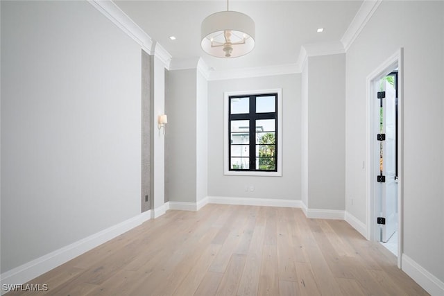 spare room with ornamental molding, light wood-type flooring, recessed lighting, and baseboards