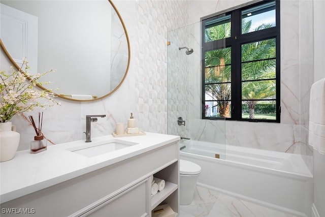 bathroom featuring marble finish floor, vanity, toilet, and shower / bathtub combination