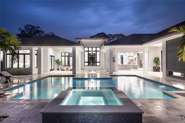 view of pool featuring a pool with connected hot tub and a patio