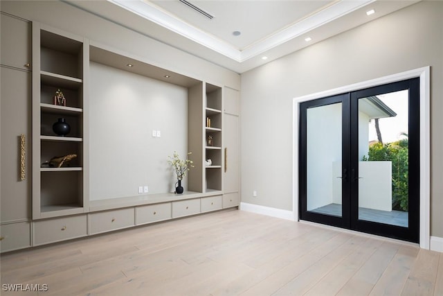 empty room featuring recessed lighting, wood finished floors, baseboards, built in features, and french doors