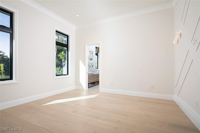 unfurnished bedroom featuring light wood finished floors, ornamental molding, and baseboards