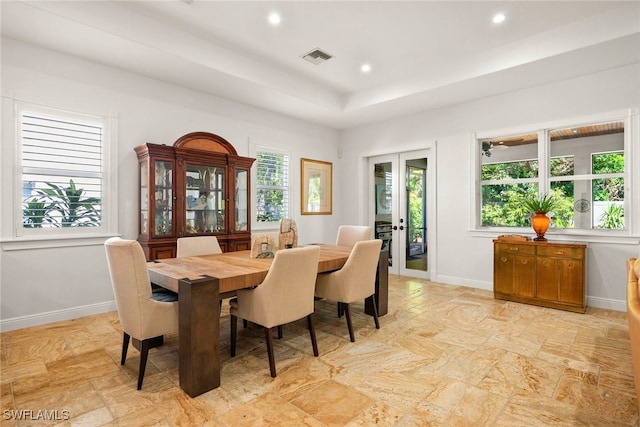 dining space with a wealth of natural light, french doors, and baseboards