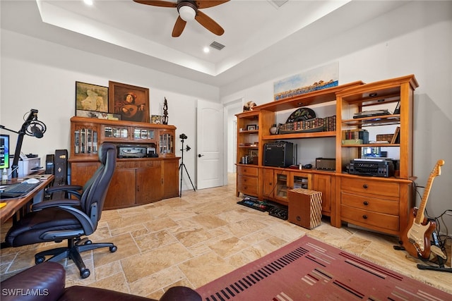 office space featuring visible vents, a raised ceiling, ceiling fan, stone finish flooring, and recessed lighting