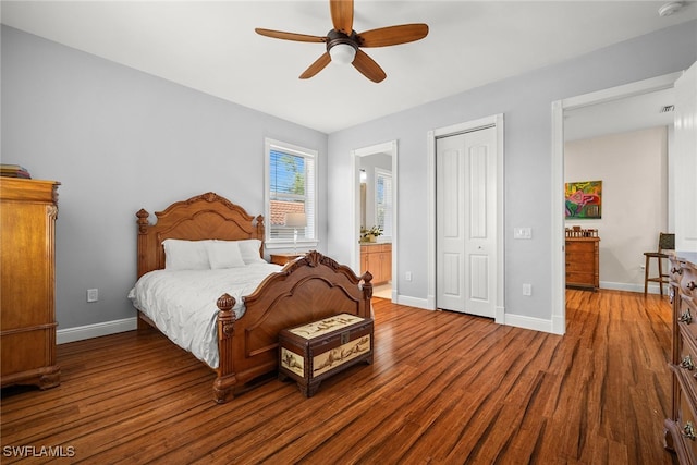 bedroom with a closet, baseboards, and wood finished floors