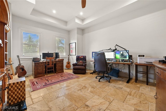 home office featuring ceiling fan, recessed lighting, baseboards, a raised ceiling, and stone tile flooring