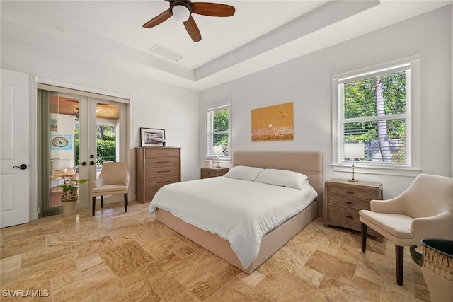 bedroom with access to outside, french doors, a raised ceiling, and ceiling fan