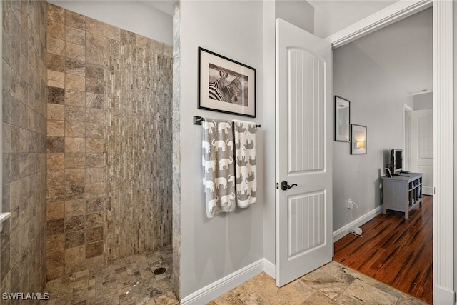 full bath featuring baseboards and a walk in shower