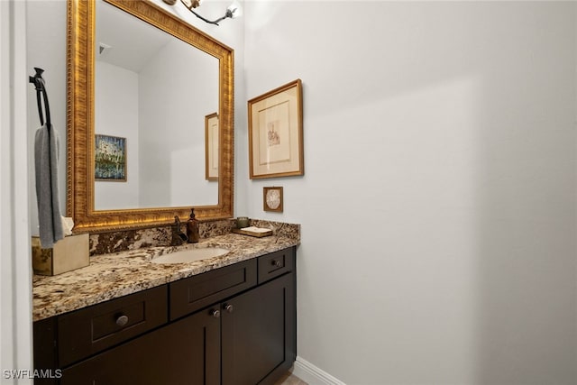 bathroom featuring baseboards and vanity