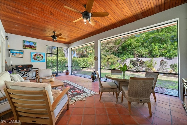 sunroom with wooden ceiling and a ceiling fan