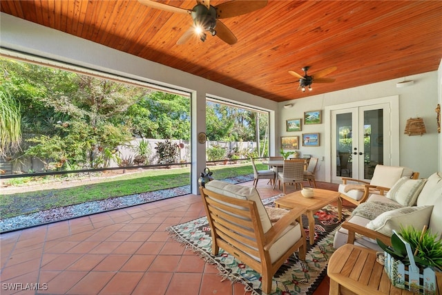 sunroom featuring wood ceiling, ceiling fan, and french doors